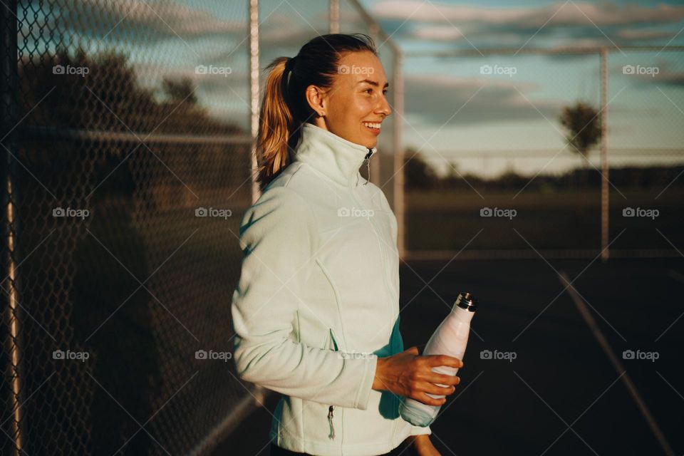 portrait photo of sports girl with water