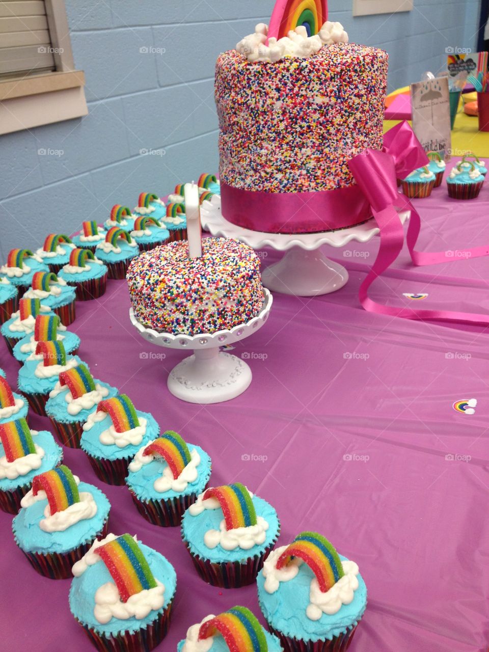 Rainbow cake and cupcakes display 