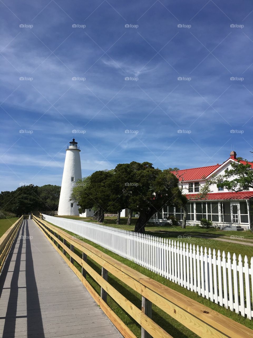 Walkway to the lighthouse at Ocracoke Inlet, NC with the lighthouse keepers residence on the right