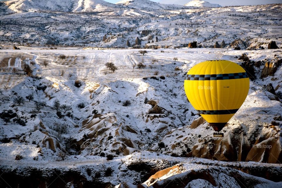 Balloon flying over cappadocia Mountains, winter, turkey