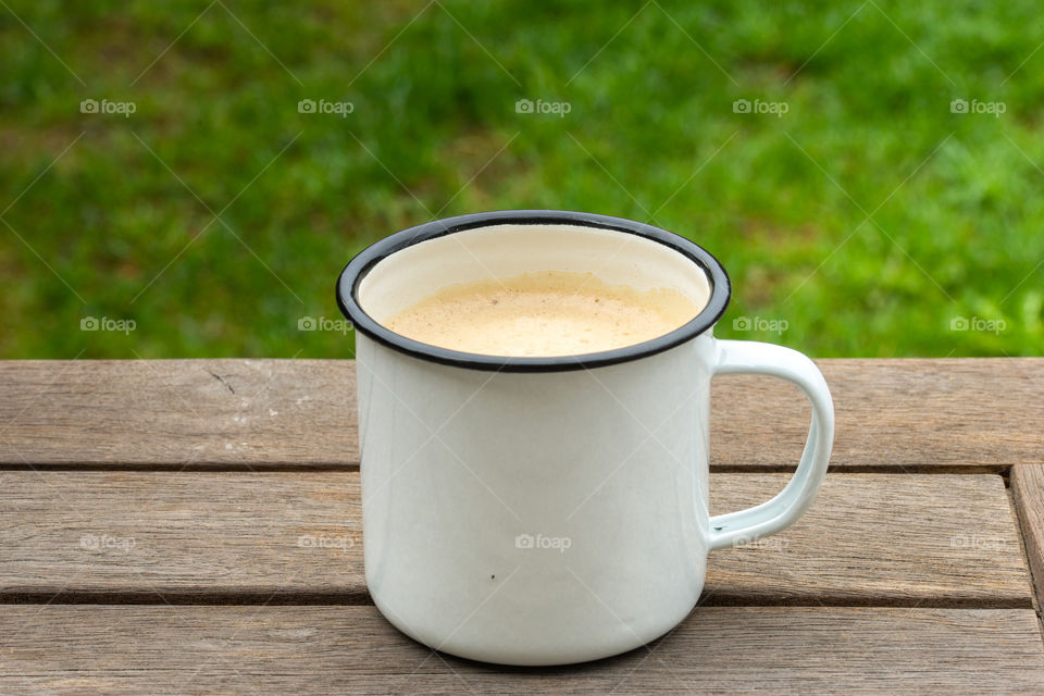 metal cup of coffee outside