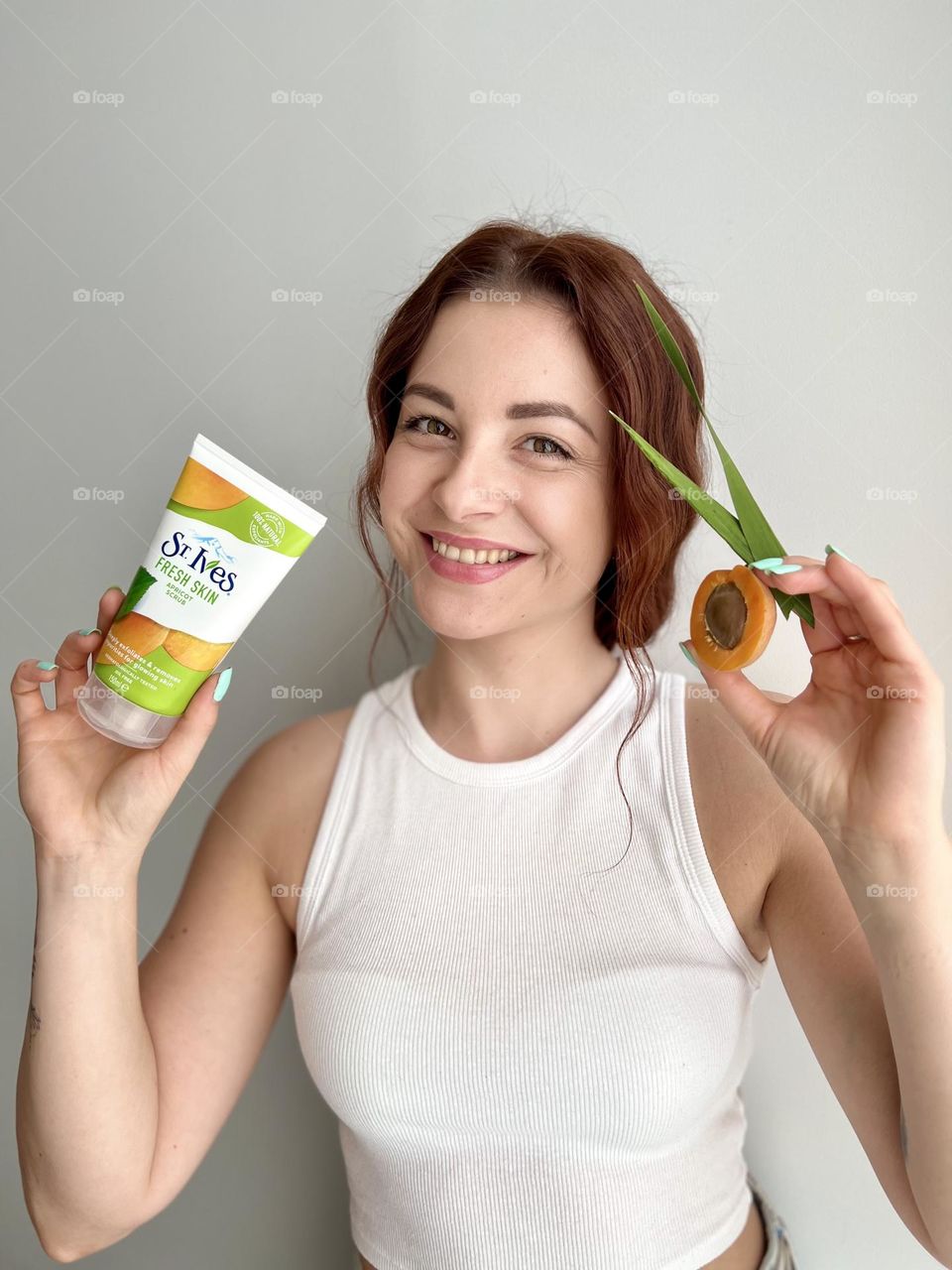 St. Ives fresh skin apricot scrub. Natural cosmetic for everyone. Photo without retouching. Natural beauty. Beautiful smile, beautiful young woman. 