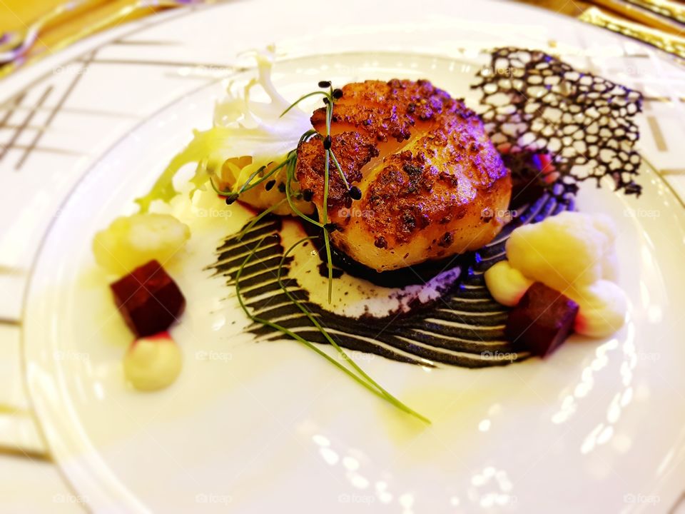 close up of fine dining food Japanese Hokkaido scallops served on a plate