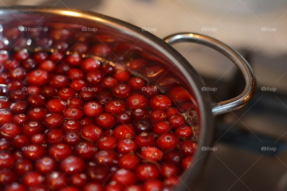 Fresh cranberries in utensil