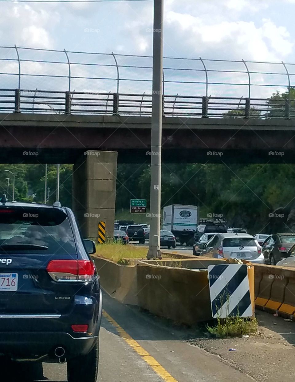 Divider barrier warnings, dangerous driving, overpass above.