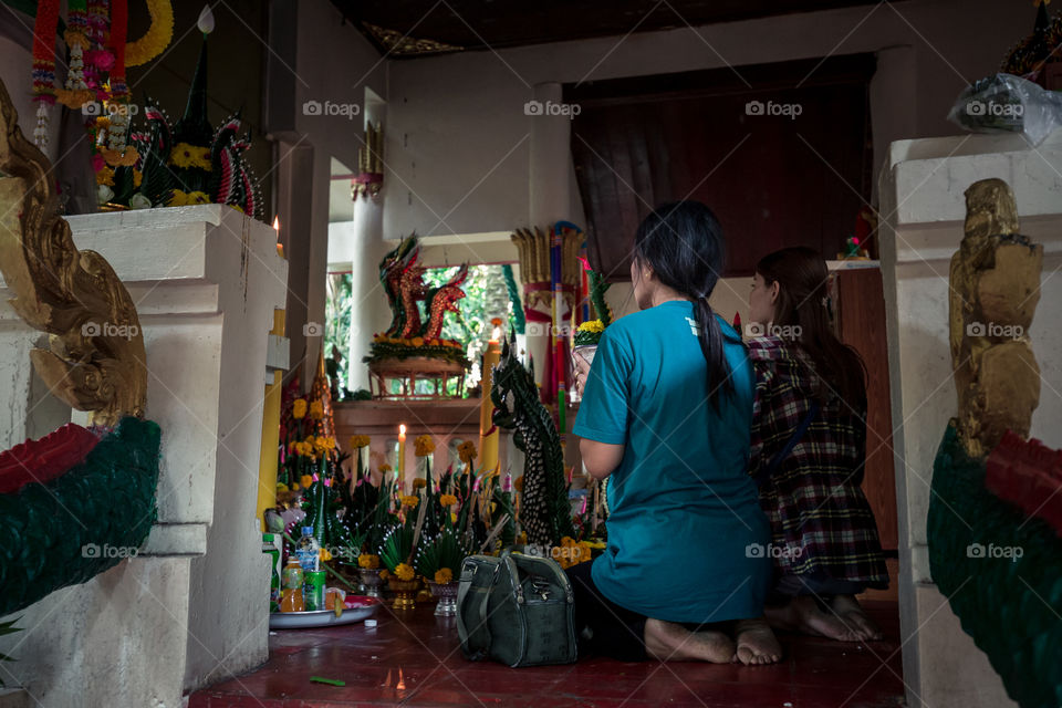 Woman pray inside the temple in Thailand 