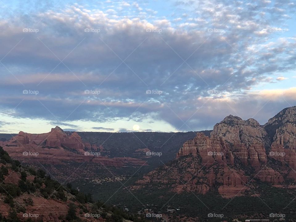 The full moon rising over Sedona as the sun sets over this spiritual, ancient land.