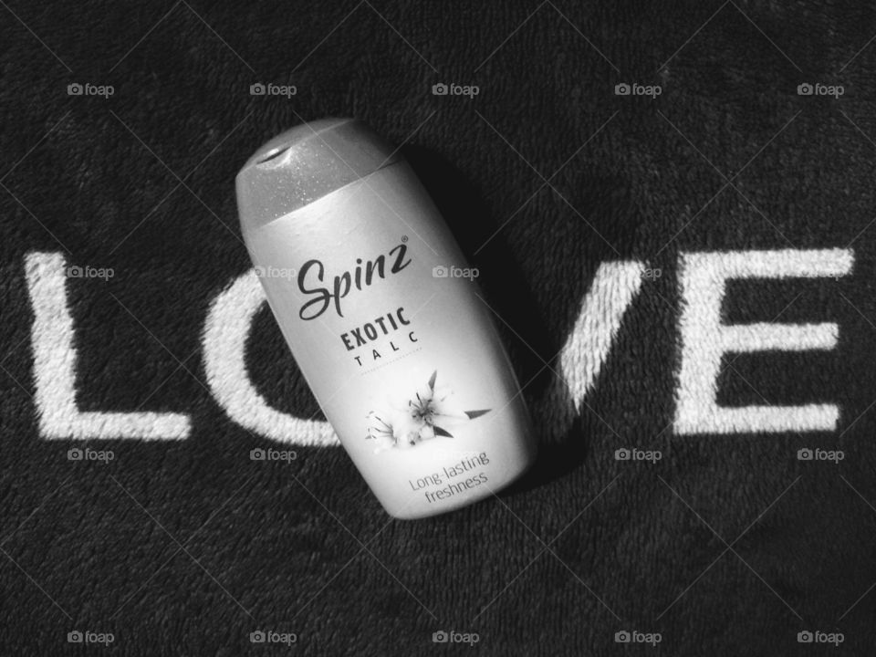 Product photography, Spinz exotic talc with velvety background. image is in black and white colour.
