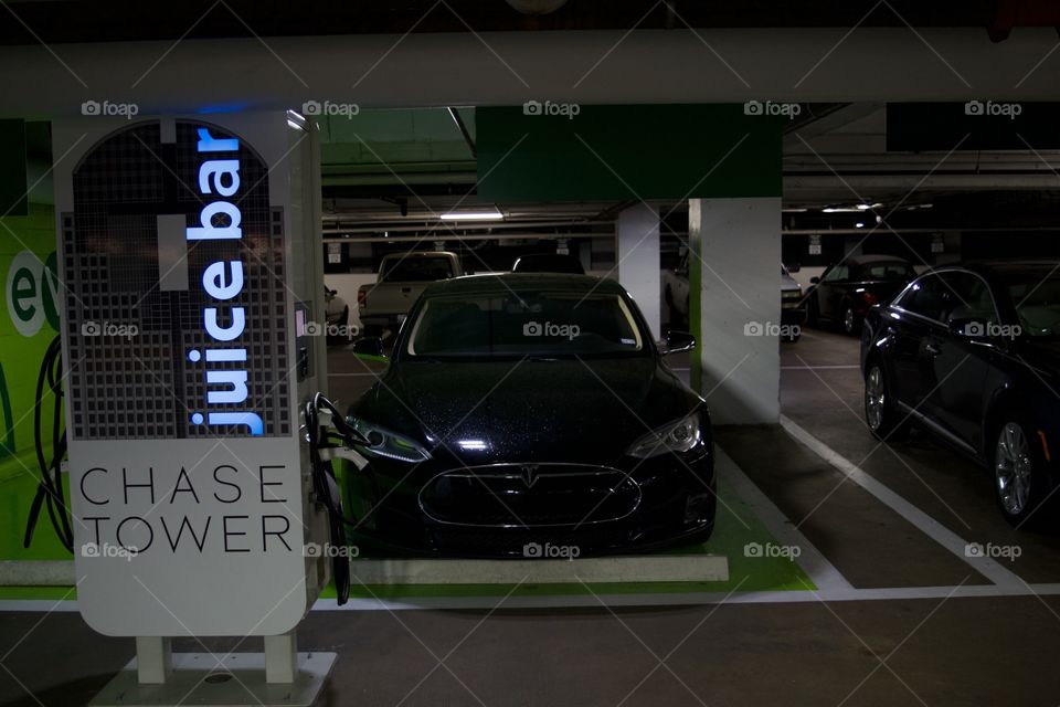 Tesla parked next to a charging station