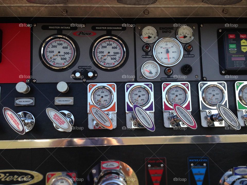 The inside of a fire engine with rows of important gauges,