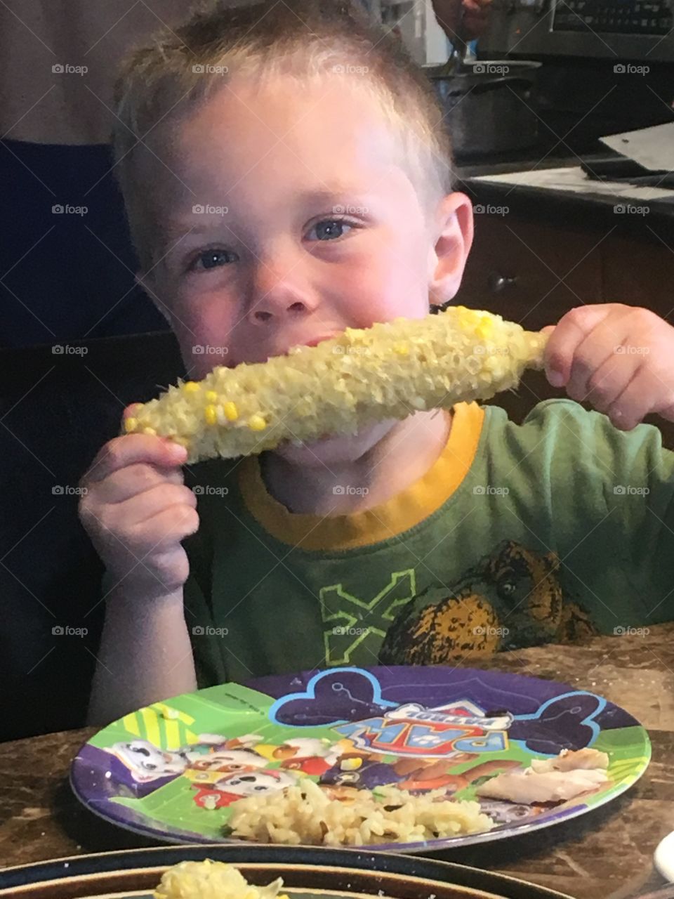 Little boy eating corn on the cob