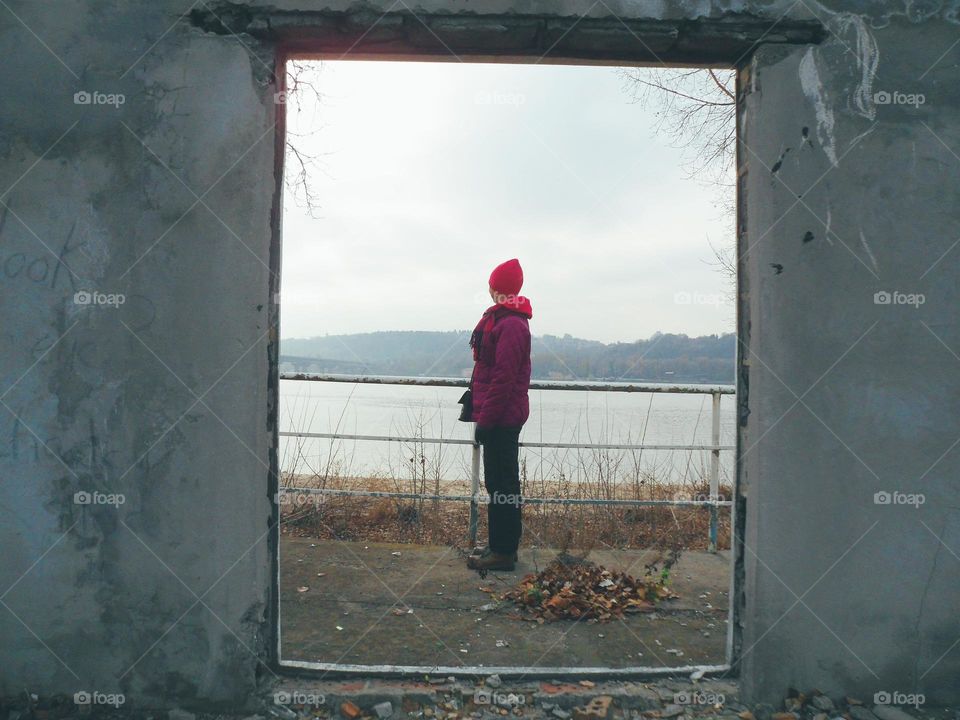 the girl in the doorway of an abandoned building