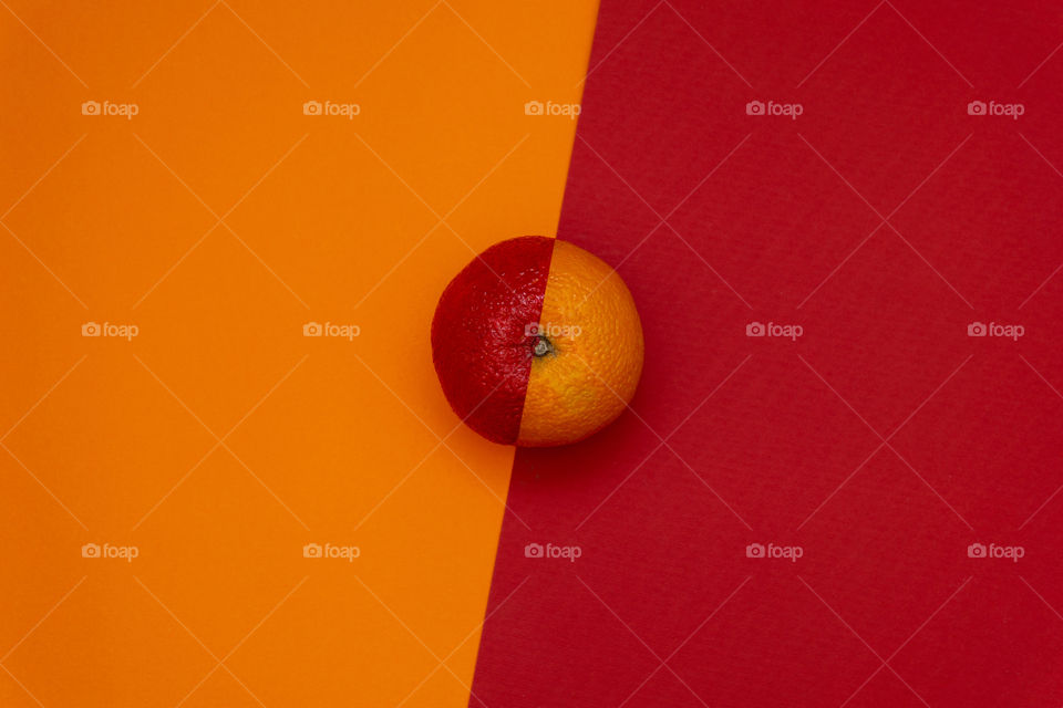 Half red orange on dualtone paper. Minimal food concept