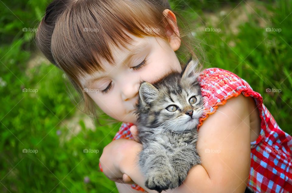 Cute girl with her pet kitten