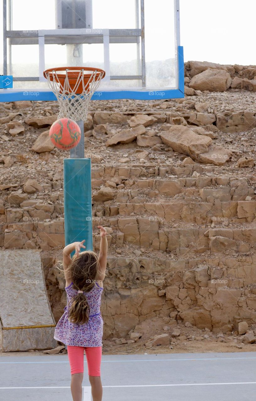 Little girl playing basketball 