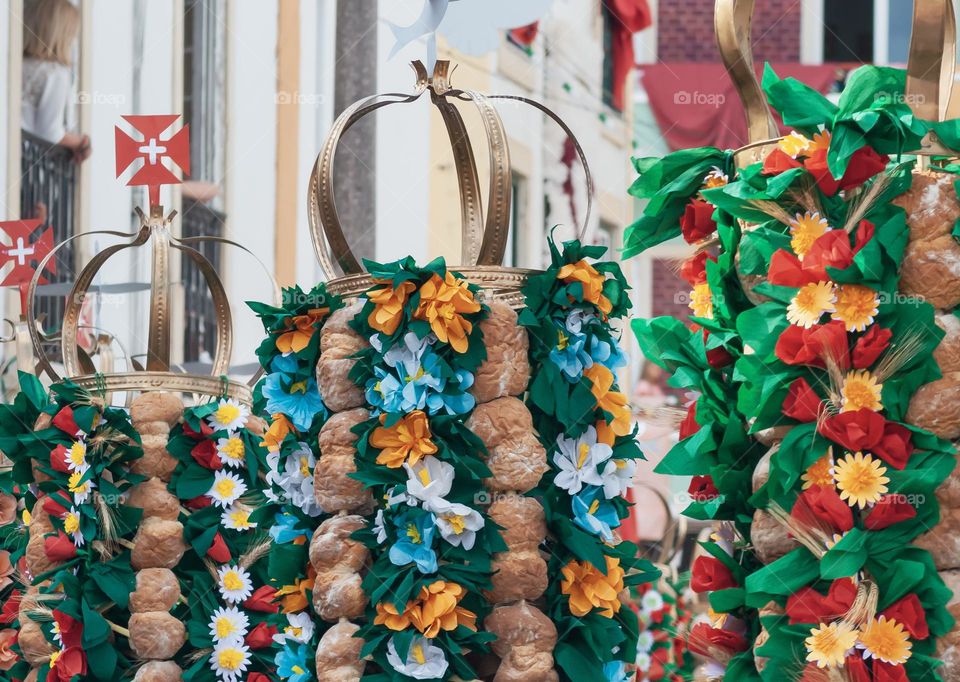 A colourful carnival procession, with people watching from balconies 