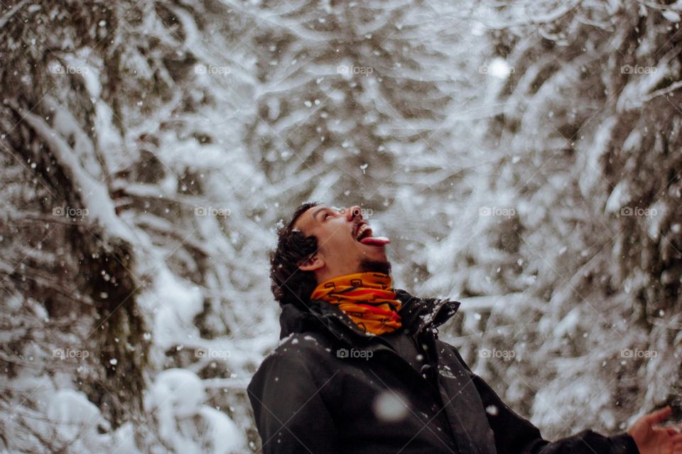 man catching snowflakes