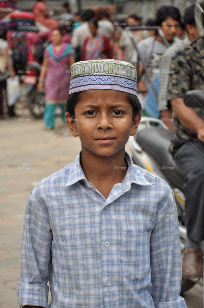 cute boy in nepalese capital kathmandu walking on the street