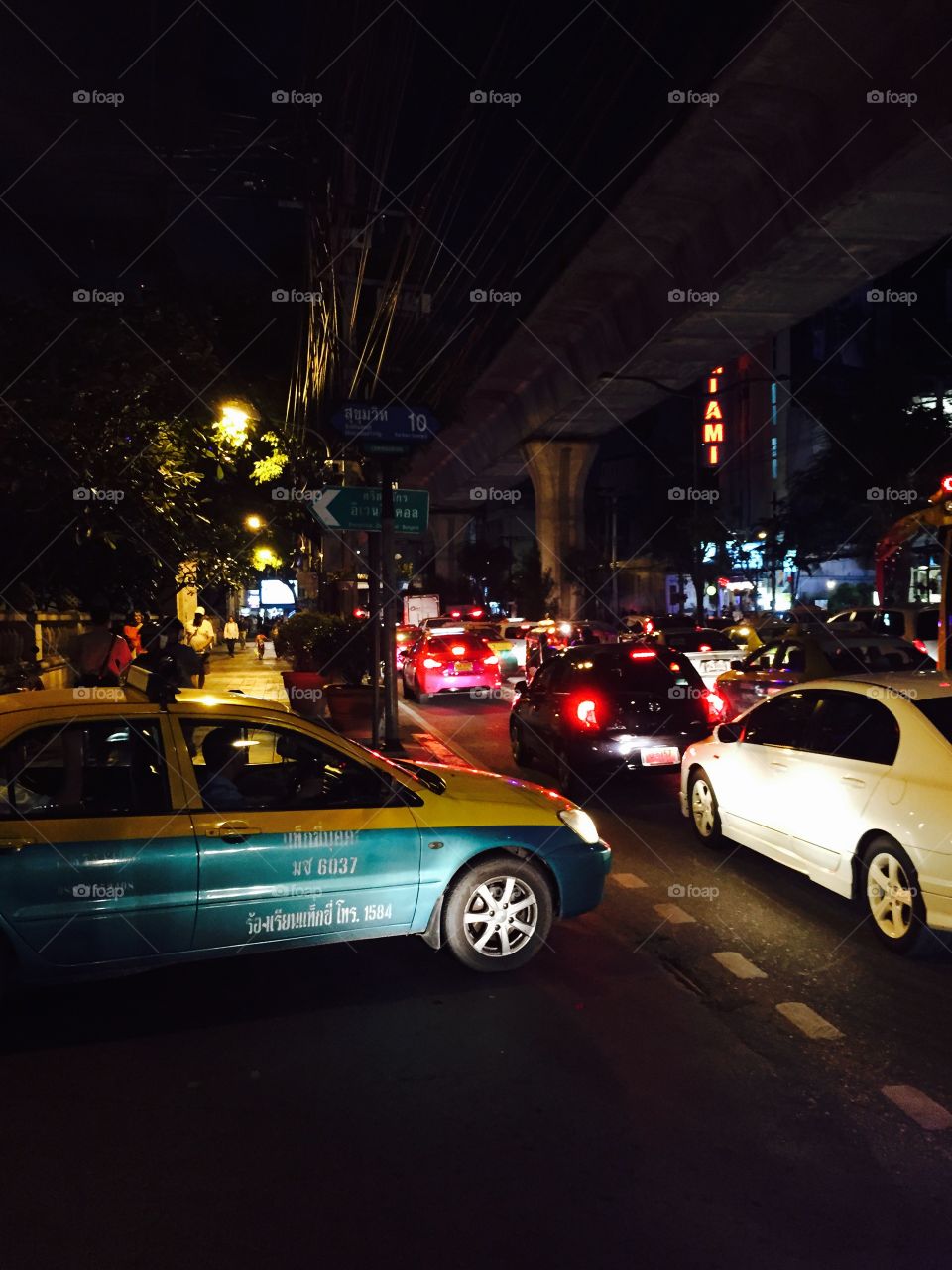 Taxi traffic in Bangkok. . Long traffic queues in Bangkok. Lights everywhere. 