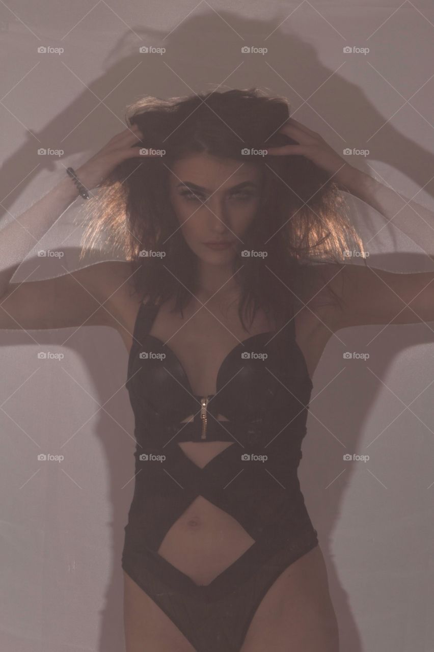 Fashion shoot in the studio. This one was taken with thee model partially behind a chiffon piece of material