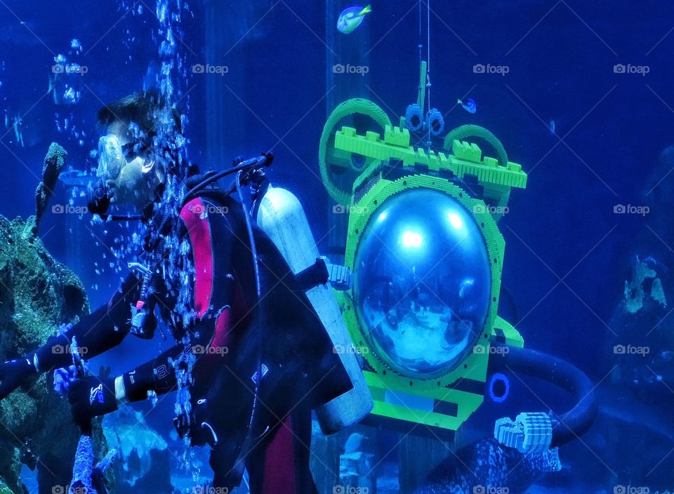 Scuba Adventure. Underwater Explorer With A Yellow Submarine
