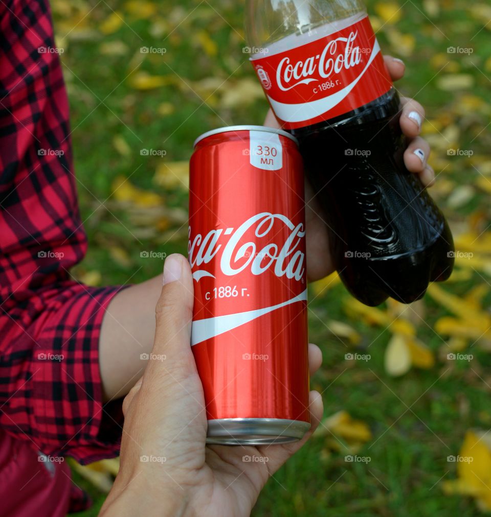 coca cola in the hands beautiful texture background