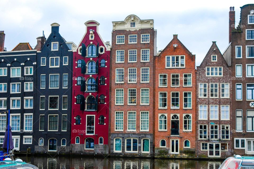 Colourful buildings on the Damrak's waterfront in Amsterdam.