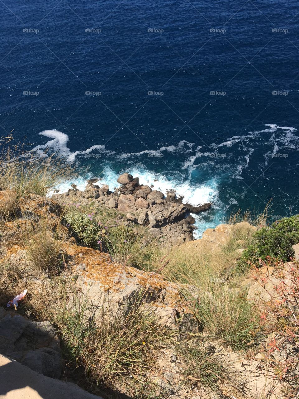 Just looking down at where the waves of the sea is hitting the land. Mallorca east coast. 