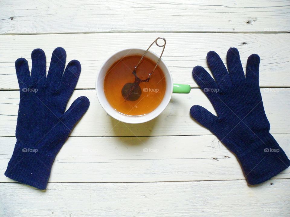 High angle view of tea and blue gloves