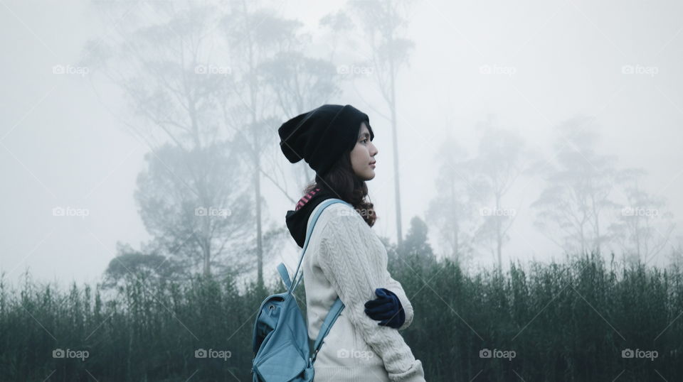 Teenage girl with backpack and woolen cap