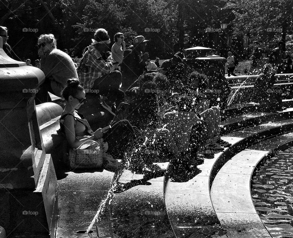 Girl reading through fountain sparkling water