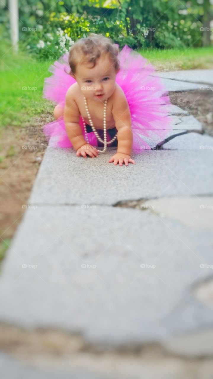 Baby ballerina crawling in park