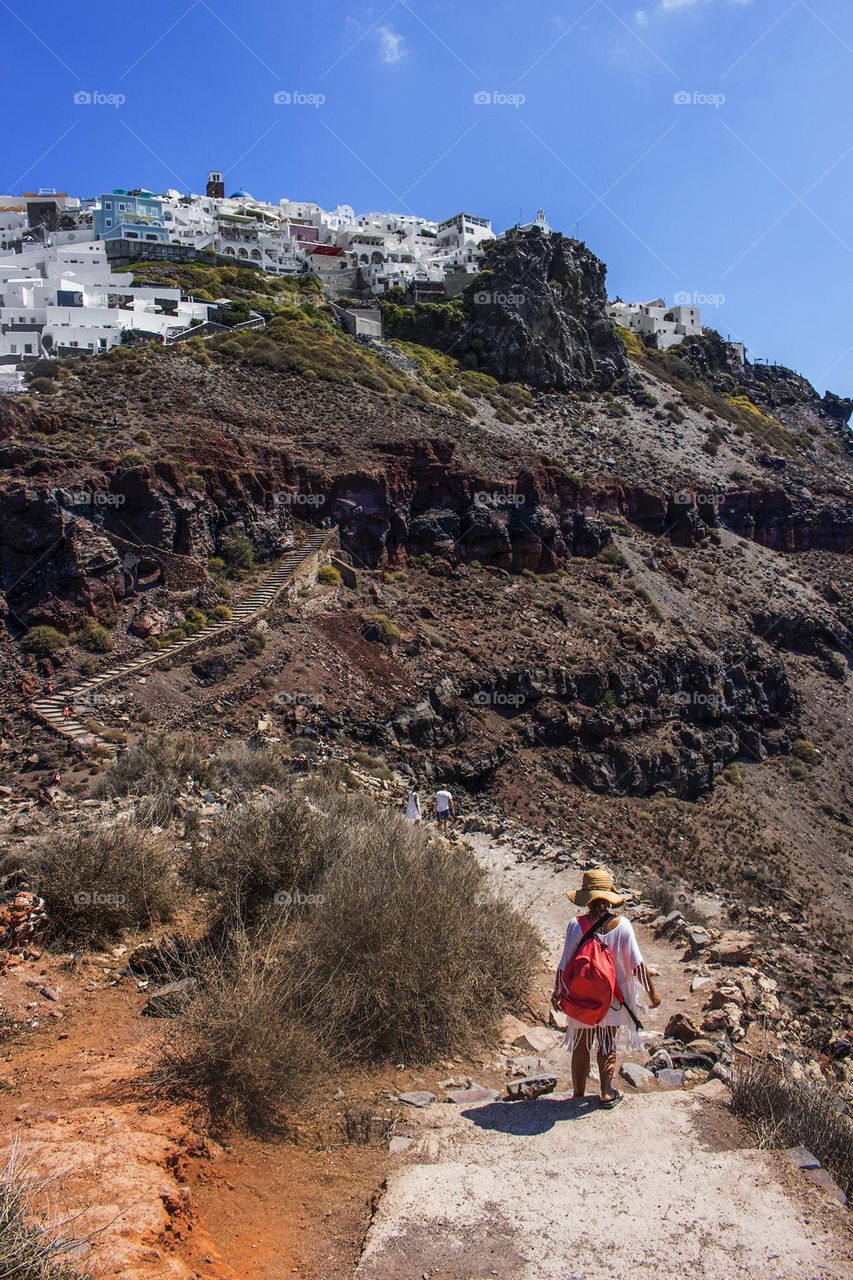 Girl walks down the path in Santorini