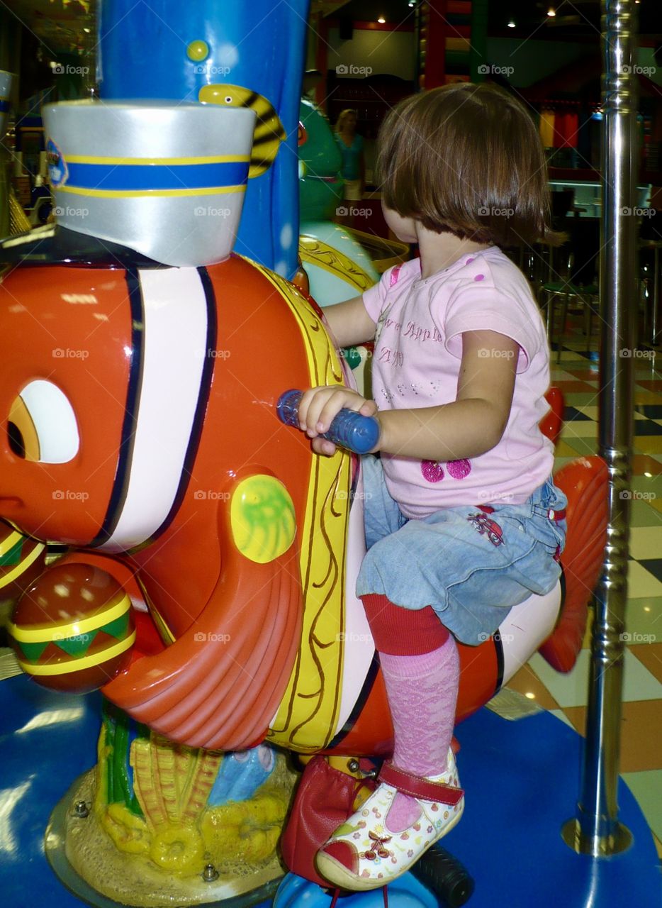 Little girl on a carousel