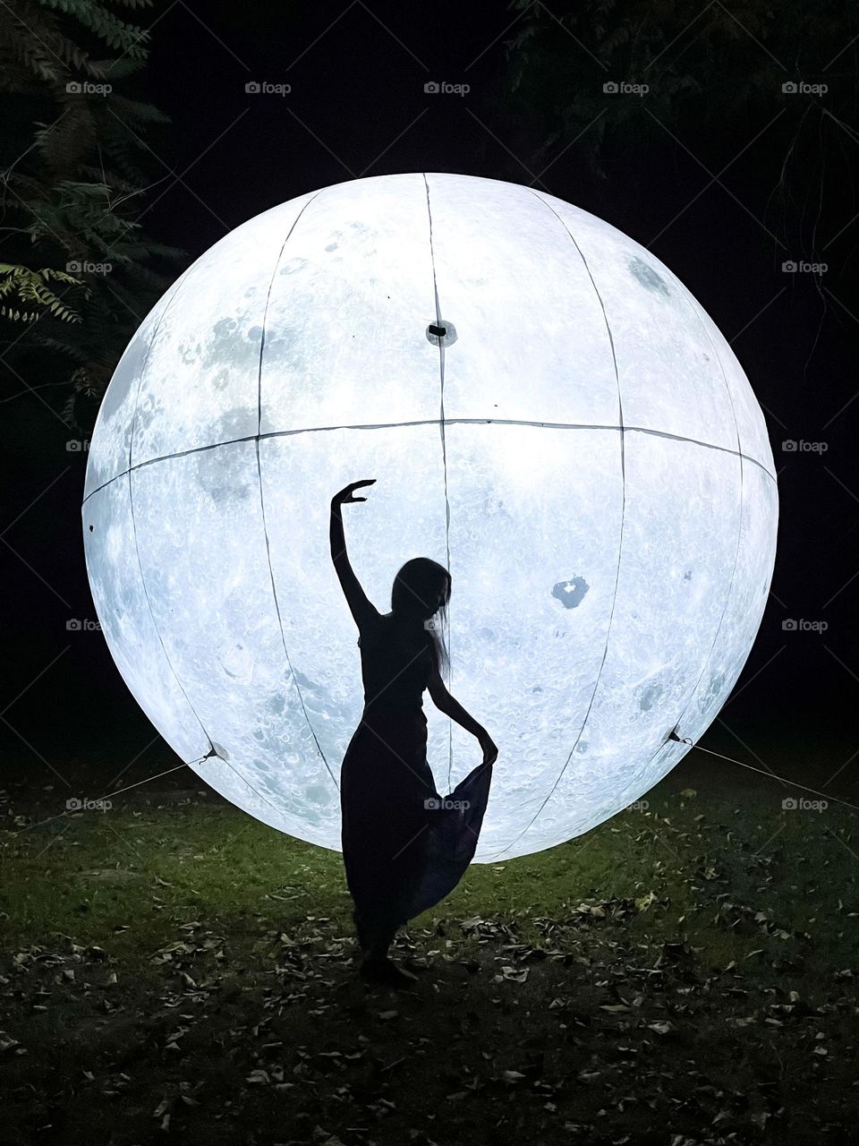 Woman Dancing in Front of the Art Installation Moon