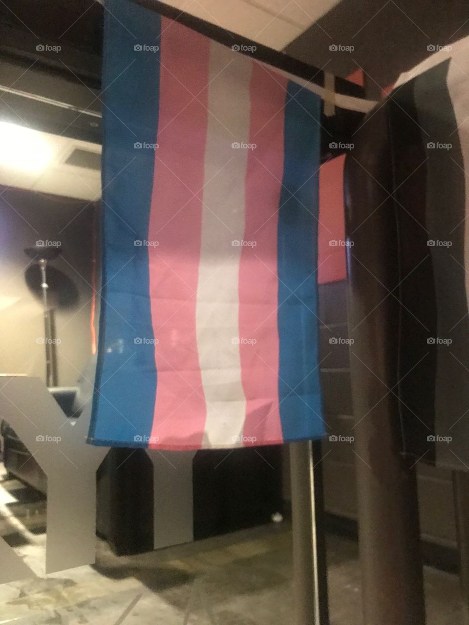 A photo of the #TransPrideFlag , which was created in the 1990’s as a symbolic representation of trans people. The light pink, darkish blue and white stand for binary trans men, binary trans women and queer non confirming (non binary trans) people