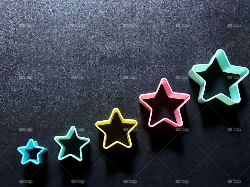 colorful stars on black leather background