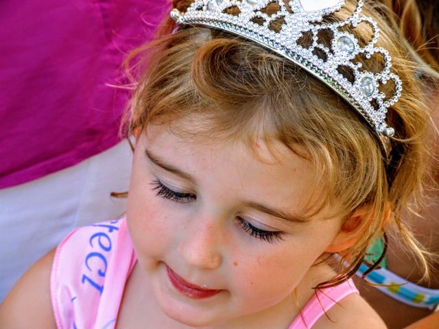 Birthday girl with tiara eyeing a piece of her cake