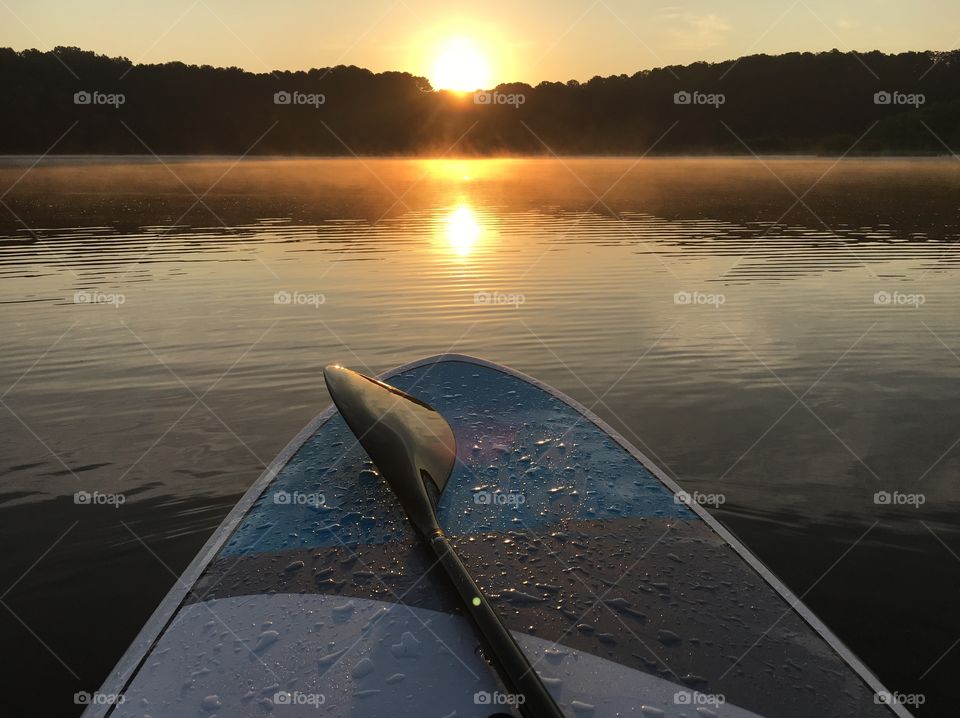 Paddle boarding at sunrise