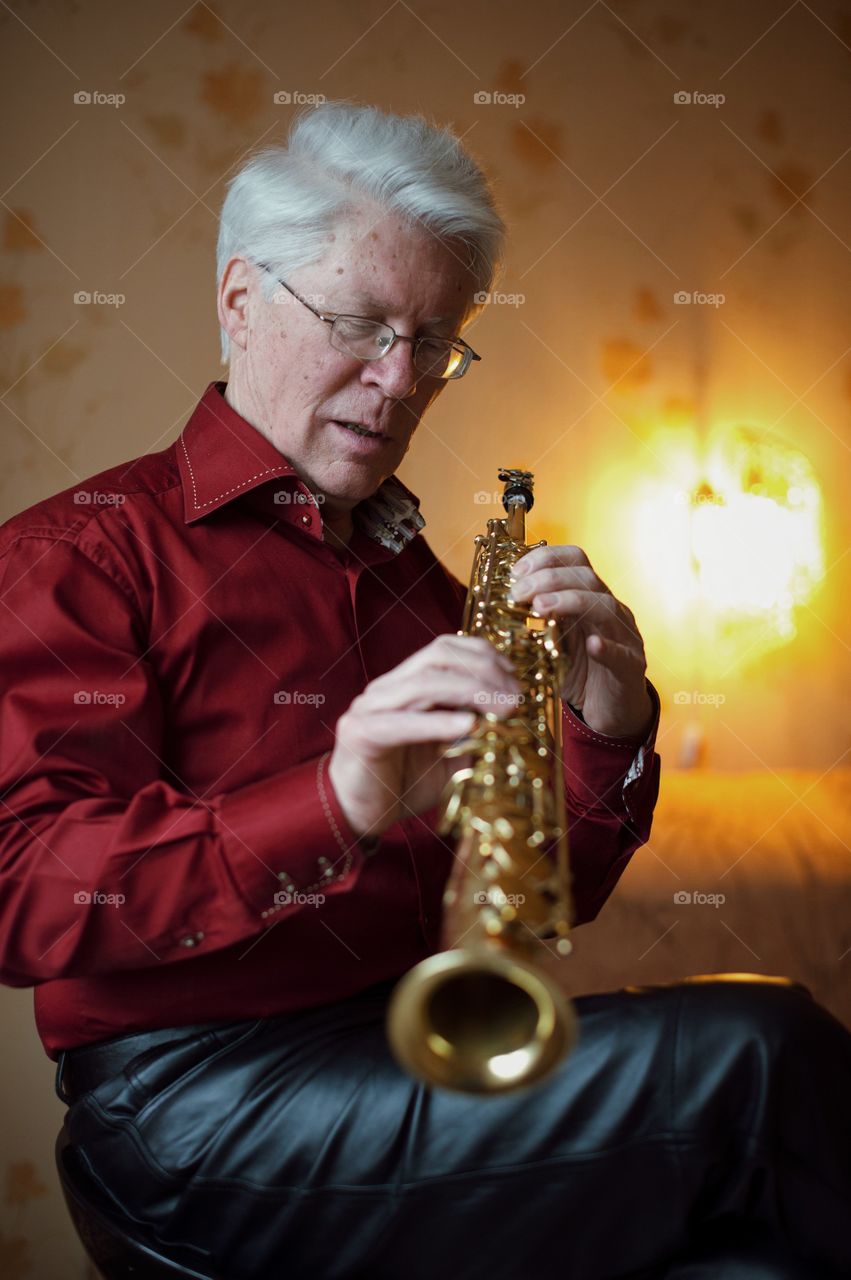 Close-up of a man holding saxophone
