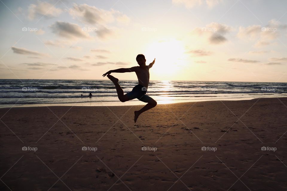 Happy summer afternoon on the beach. Flying kid