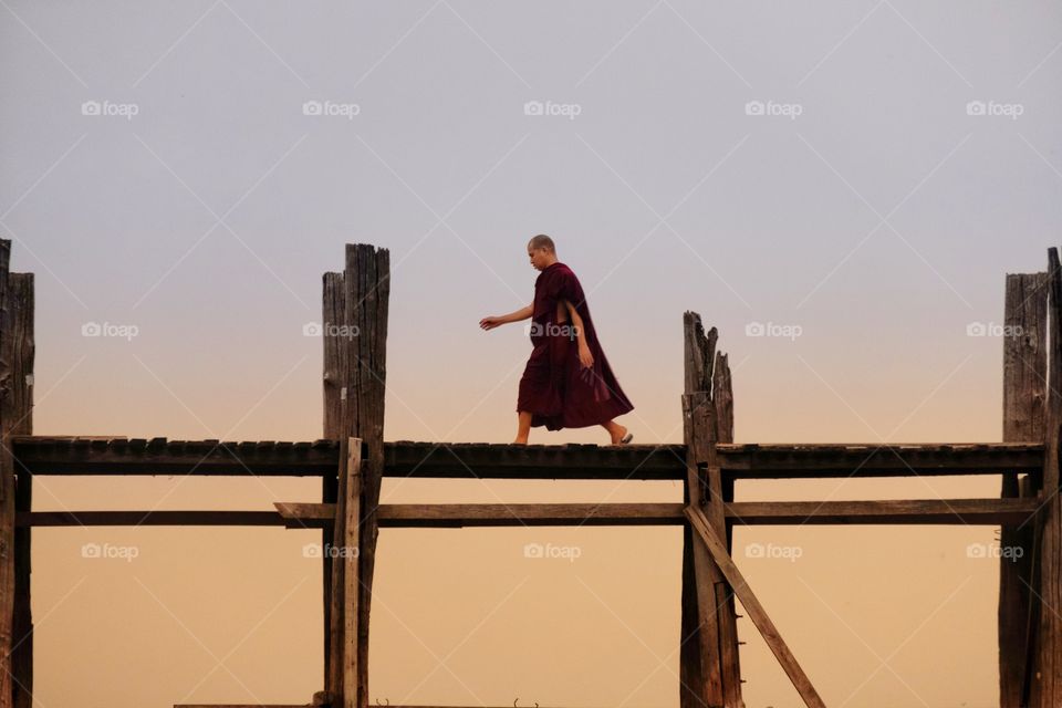 Local monk is walking on U Bein the longest wooden bridge in the world,Mandalay Myanmar 