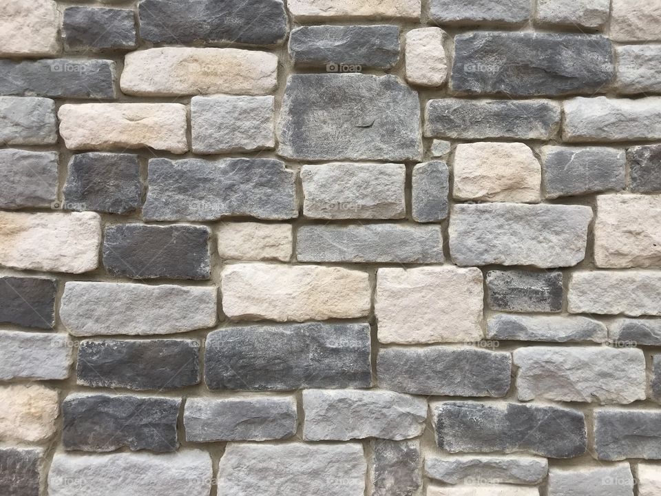 Building wall made from gray and white stone