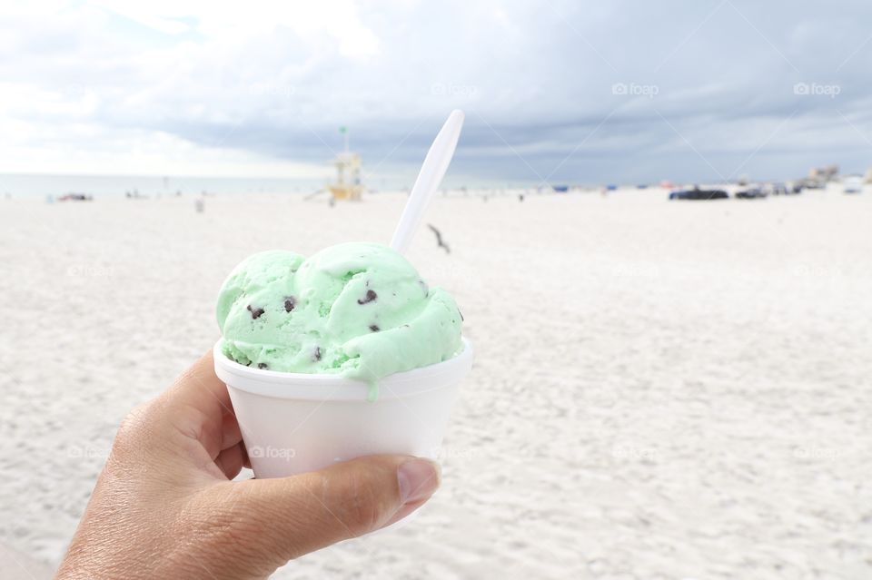 Having mint ice cream with chocolate chip on the beach 