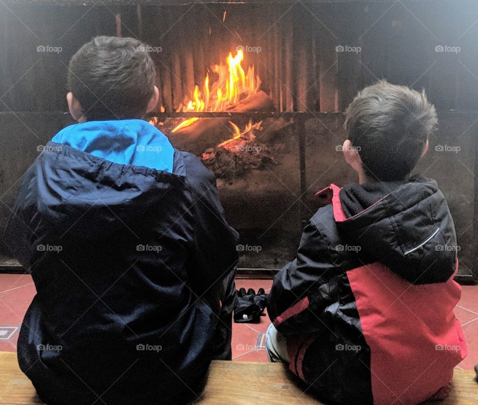 Brothers warming up by the fire
