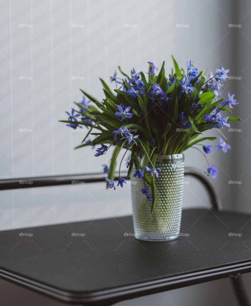 Spring flowers in a vase in black table 