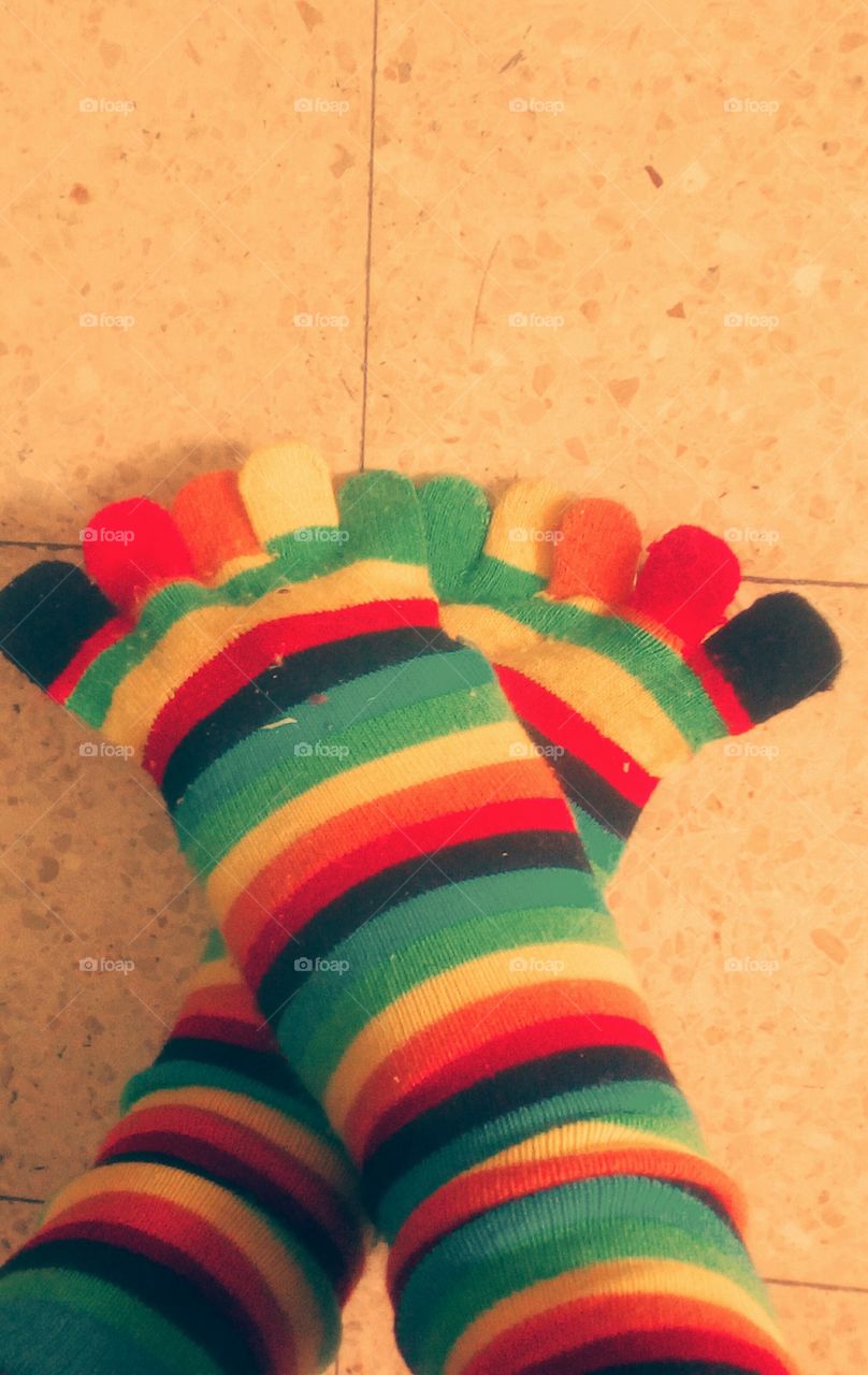 Funny rainbow color woolen stockings
on people legs