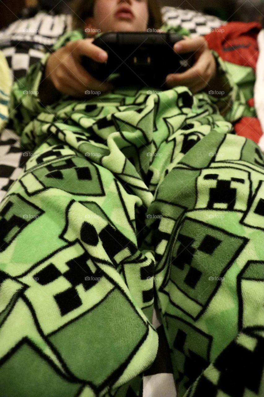 Girl playing video games with her pyjama 