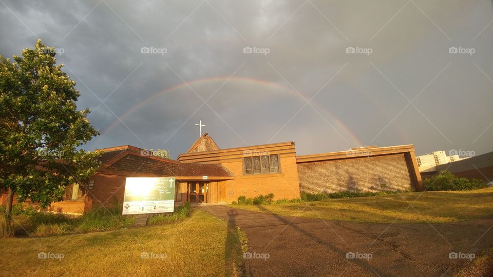 A rainbow over a church,  how fitting.