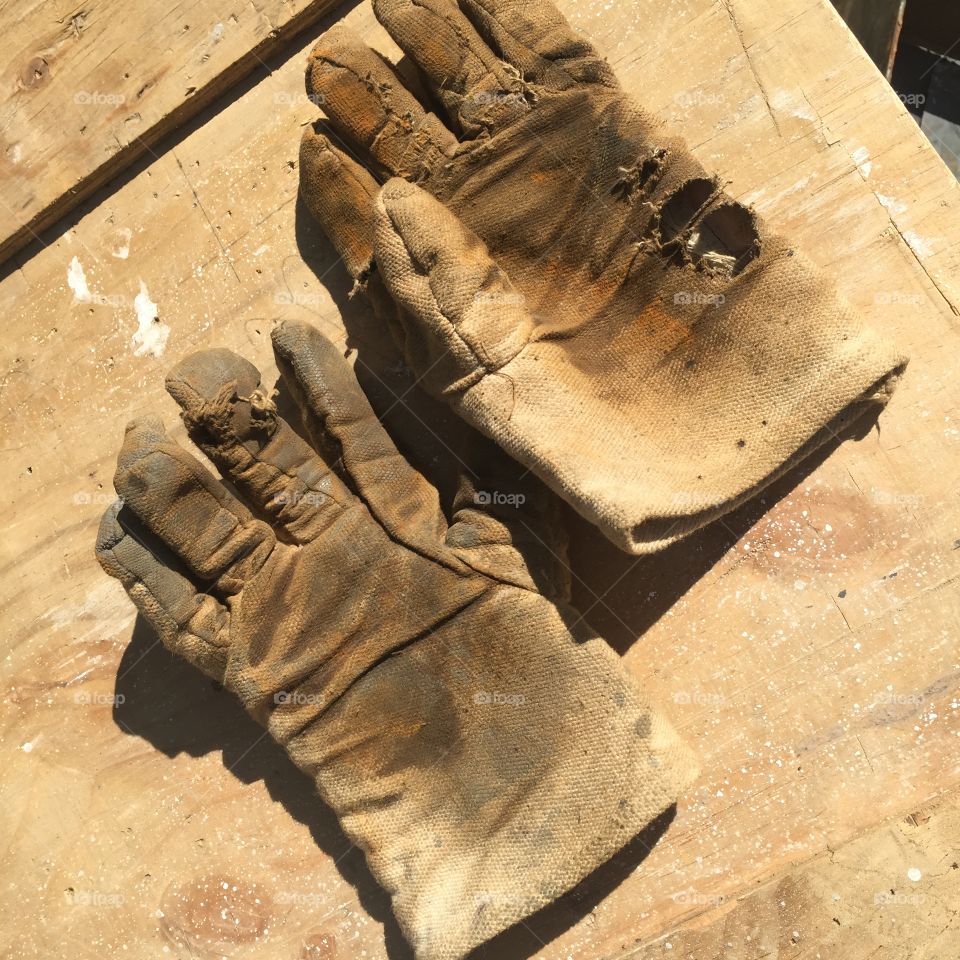 A pair of broken gloves